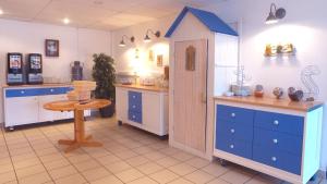 a kitchen with blue cabinets and a blue door at VVF Les Plages de Guérande La Turballe in La Turballe