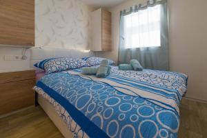 a bedroom with a bed with two stuffed animals on it at Mobile Homes Pine Tree in Dobropoljana