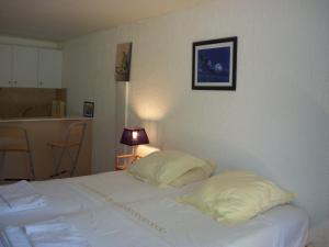 a bedroom with a bed with two pillows on it at Le Jardin d Eden in Sainte-Maxime +51 photos