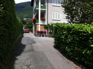 a building with a street in front of a house at Casa al Lido in Locarno