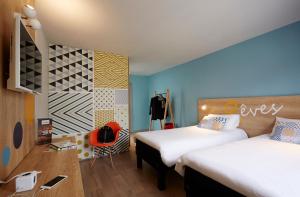 Postel nebo postele na pokoji v ubytování Hôtel Baudouin