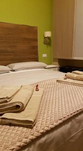 a bedroom with two beds with towels on them at B&B VIA VENETO in Crotone