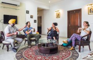 a group of people sitting in chairs in a living room at Palm 34 in Jaipur +54 photos