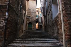 an alley in an old town with steep stairs at B&B Da Zia Ore in Iesi