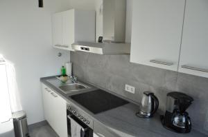 cocina con fregadero y encimera en Ferienwohnung Weitblick en Velbert