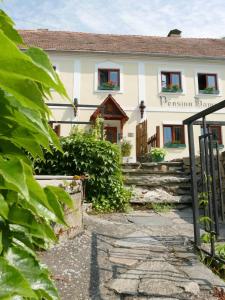 a house with a gate in front of it at Pension Hamry in Vranov nad Dyjí