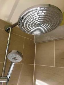 
a shower stall with a shower head on the wall at The Black Horse at Ireland in Shefford
