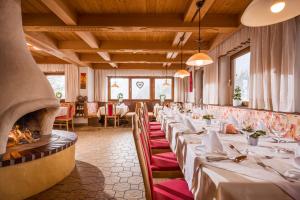 a row of tables in a restaurant with a fireplace at Biolandhaus Seethaler in Vorderthiersee