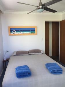 A bed or beds in a room at Toowoon Bay Beachfront Apartment