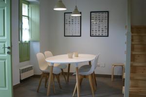 a dining room with a white table and chairs at Las Casinas de la Granda in Nueva de Llanes +15 photos