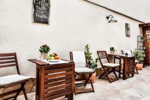 a patio with chairs and a table with fruit on it at Accommodation Smečky 14 in Prague
