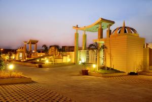 a parking lot with a skate park at night at Cambay Grand Kukas in Jaipur