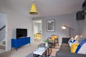 a living room with a couch and a tv at My Tetamu Apartment Coventry in Coventry