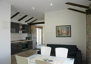 a kitchen and living room with a table and chairs at Holiday Home Demark in Jurdani