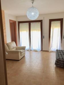 a living room with a couch and two windows at Le Villette in Pescara