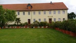 a large white building with a green lawn in front of it at Kornkäfer Kleinmockritz in Döbeln +7 photos