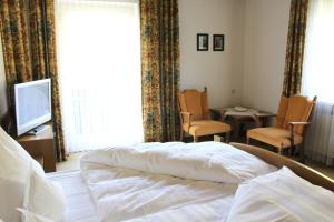 Postel nebo postele na pokoji v ubytování Hotel Alpina