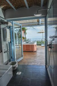 a bathroom with a shower and a view of the ocean at Beyaz Yunus Hotel - Adult Only in Oludeniz