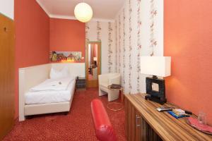 um quarto com uma cama e uma secretária com uma cadeira em Stadthotel Hauser Eck em Sankt Pölten