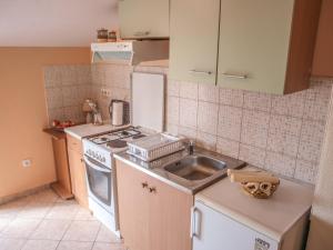 a kitchen with a sink and a stove top oven at Apartment Pletikosic in Kaštela +13 photos