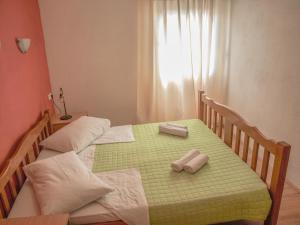 two twin beds in a bedroom with towels on them at Apartment Pletikosic in Kaštela