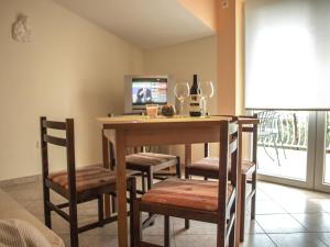 a dining room with a table with chairs and a television at Apartment Pletikosic in Kaštela