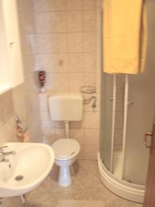 a bathroom with a toilet and a sink and a shower at Apartment Pletikosic in Kaštela