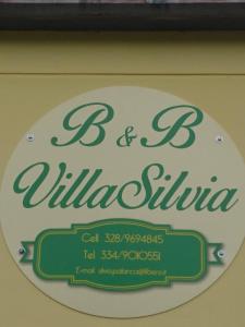 a sign for a restaurant with a green and white sign at Villa Silvia in Acquasanta Terme