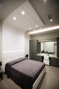 a bedroom with a large bed and a bathroom at Gramsci 21 Rooms in Naples