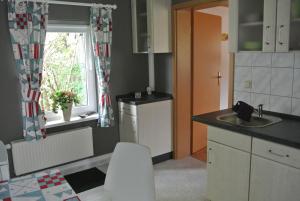 a kitchen with a sink and a counter and a window at Ferienhaus Katja in Wienrode