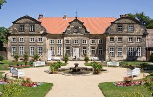 an old building with a fountain in front of it at Ferienhaus Katja in Wienrode