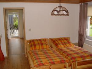 a bedroom with two beds in a room with a table at Ferienhaus Katja in Wienrode