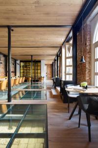 an open room with glass tables and chairs at Palacio de los Duques Gran Meliá - The Leading Hotels of the World in Madrid