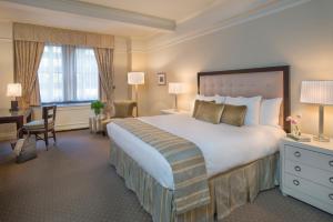 
a hotel room with two beds and a desk at Warwick New York in New York
