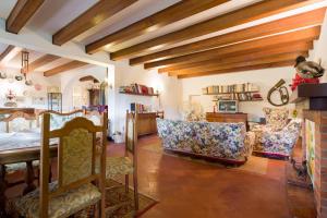 a living room with a bed and chairs and a table at Tamerici Holiday Home by VacaVilla in San Miniato