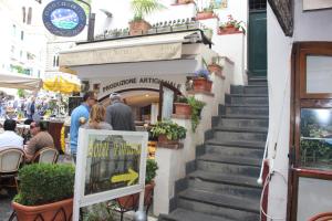 a group of people walking down the stairs of a building at Hotel Fontana in Amalfi