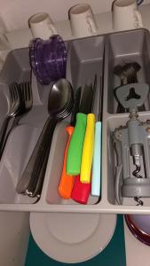 a drawer filled with utensils on a shelf at Nice Apart backpackers S5 in Nice