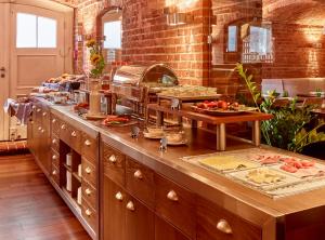 a kitchen with a counter with food on it at Hotel Navigare Buxtehude in Buxtehude