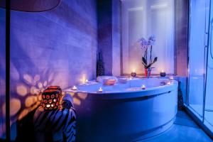 a bathroom with a tub with candles in it at Town House Spagna- luxury Rooms with Jacuzzi Bath in Rome
