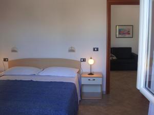 A bed or beds in a room at Residence e B&B La Cappella Del Convento