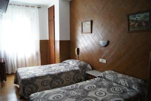 Postel nebo postele na pokoji v ubytování Hostal Sanmar