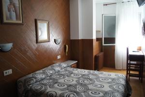 Postel nebo postele na pokoji v ubytování Hostal Sanmar