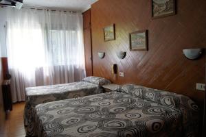 Postel nebo postele na pokoji v ubytování Hostal Sanmar