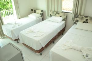 En eller flere senger på et rom på Hotel Icamiabas
