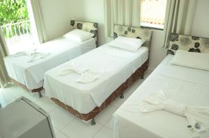 A bed or beds in a room at Hotel Icamiabas