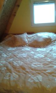 a white bed in a room with a window at Apartment MG in Žabljak