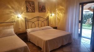 Postel nebo postele na pokoji v ubytování B&B Da Sabrina