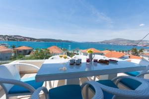 a blue table with food and drinks on a balcony at Apartments Soho in Trogir