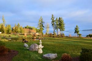 a statue of a girl in a park with rocks at Two Eagles Lodge in Union Bay