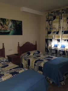 A bed or beds in a room at Pension Meson Paz